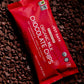 Red package of Just Date Organic Milk Chocolate Chips on a bed of chocolate chips